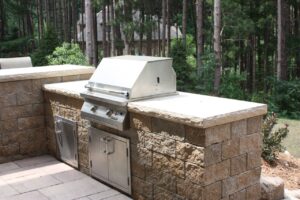 A custom outdoor cooking area done by Signature Decks & Construction. The grilling station is built into the facde, not wheeled out whenever you need a bbq.