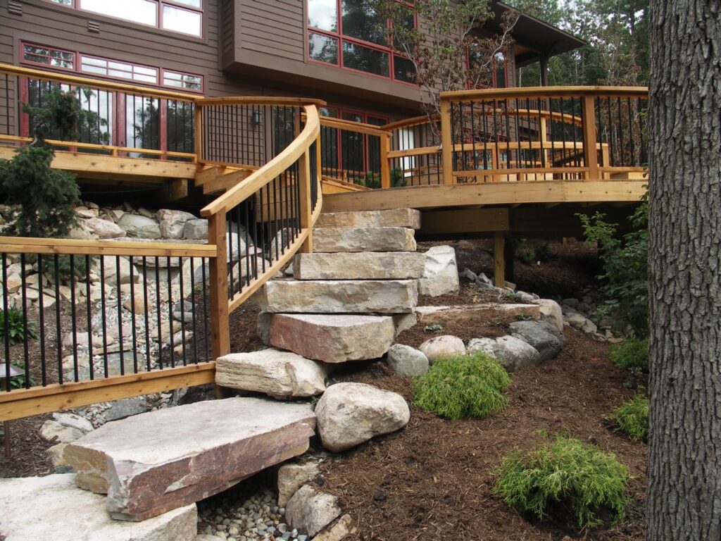 Signature is a deck builder in the greater Grand Rapids area. A deck design that incorporates stone landings and landscape.