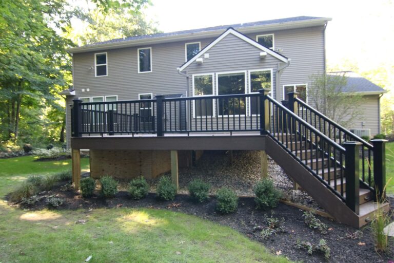 Deck elevation is an important requirement during the construction process. An elevated deck off a sloped backyard of a house.