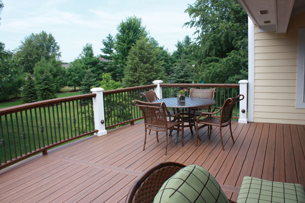 A Signature Deck with a view of a neighboring forest. For expert deck builders in Cascade MI, trust Precision.