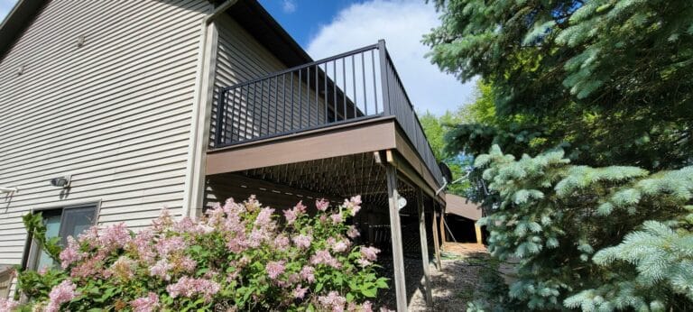 a custom balcony with fencing created by signature decks