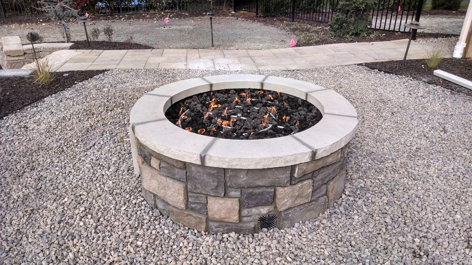 A backyard fire pit. Design and build services by Signature Decks & Construction